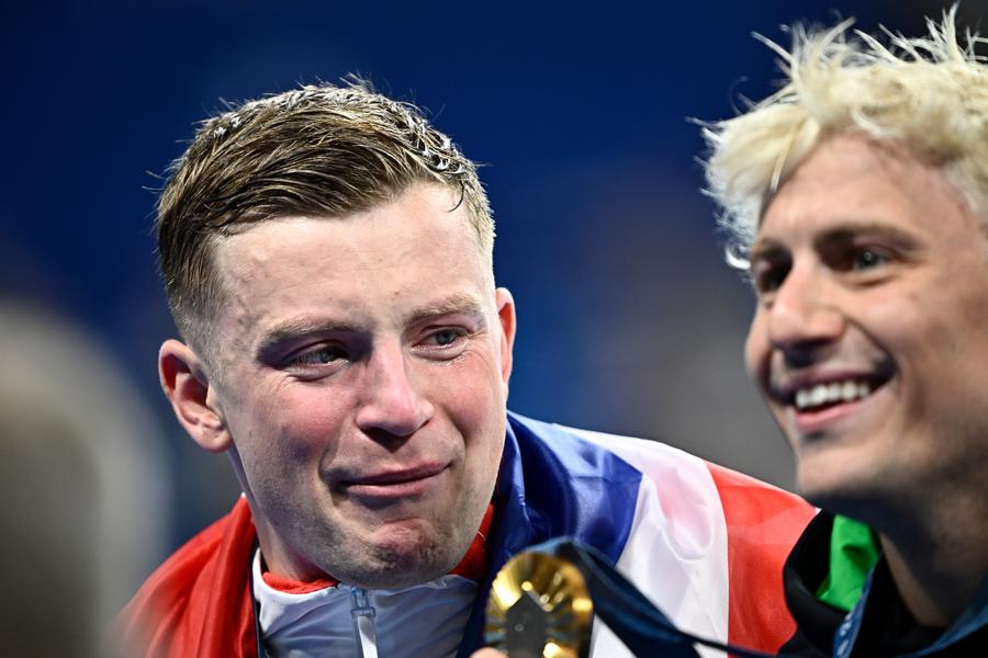 (PHOTO shows silver medalists Adam Peaty of Britain reacts as Gold medalist Nicolo Martinenghi of Italy shows the medal after the awarding ceremony of men's 100m breaststroke of swimming at the Paris 2024 Olympic Games in Paris, France, July 28, 2024- Xinhua.)